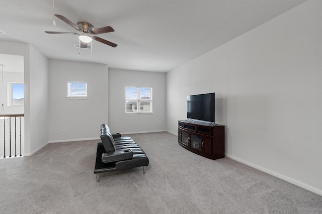 living area featuring ceiling fan and light carpet