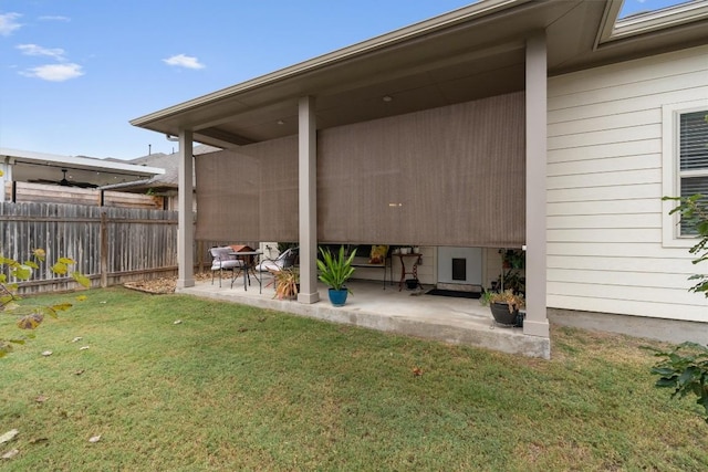 rear view of house with a yard and a patio