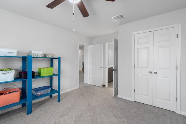 bedroom featuring light carpet, a closet, and ceiling fan