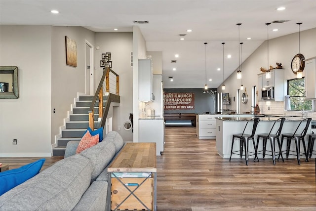 106 Center Cove Ii Loop, Spicewood, TX 78669 - living room featuring wood finished floors, stairway, recessed lighting, and high vaulted ceiling
