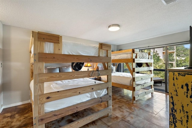 tiled bedroom with a textured ceiling