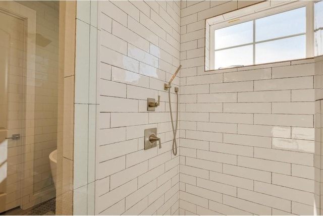 bathroom with tiled shower