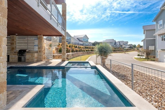 200 Archview Ln, Kingsland, TX 78639 - view of pool featuring an outdoor kitchen, a residential view, and a pool with connected hot tub