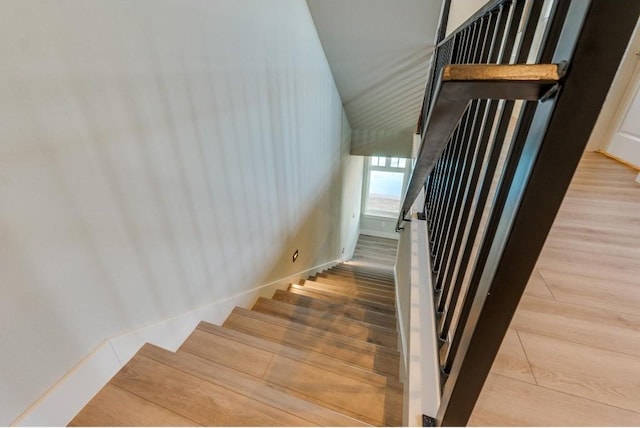 staircase with hardwood / wood-style flooring