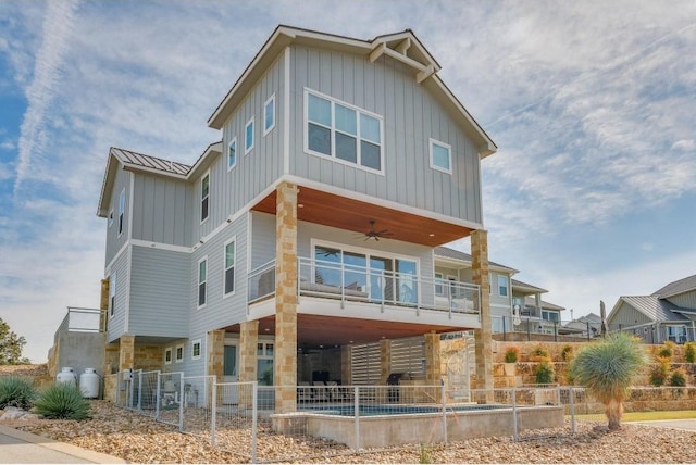 rear view of house featuring a balcony and ceiling fan