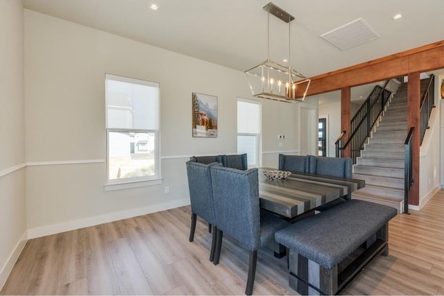 dining space featuring a notable chandelier and light hardwood / wood-style flooring