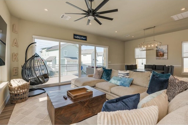 living room featuring ceiling fan and light hardwood / wood-style floors