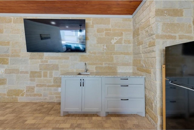 200 Archview Ln, Kingsland, TX 78639 - kitchen featuring freestanding refrigerator, light stone counters, a sink, and white cabinets