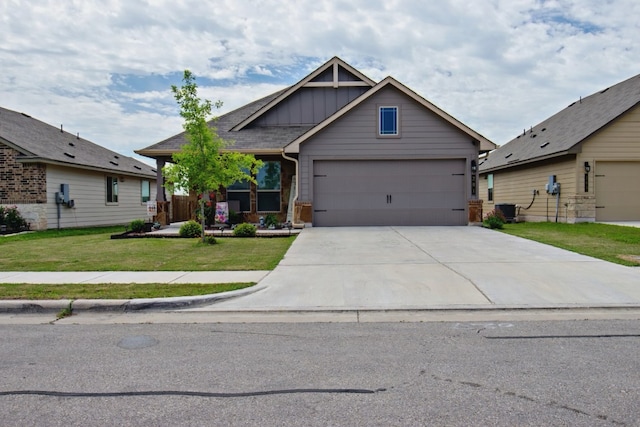 craftsman inspired home featuring a garage, a front yard, and central AC unit