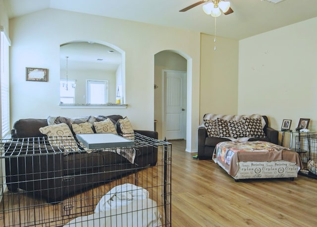 living room featuring lofted ceiling, wood-type flooring, and ceiling fan