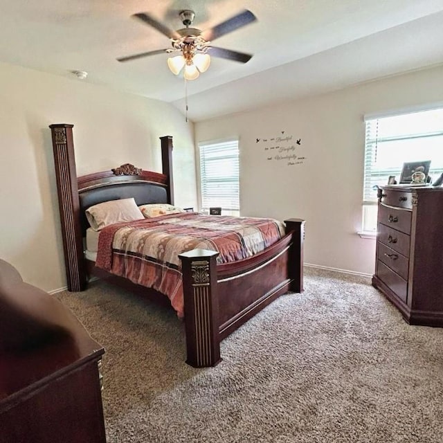 carpeted bedroom with multiple windows, lofted ceiling, and ceiling fan