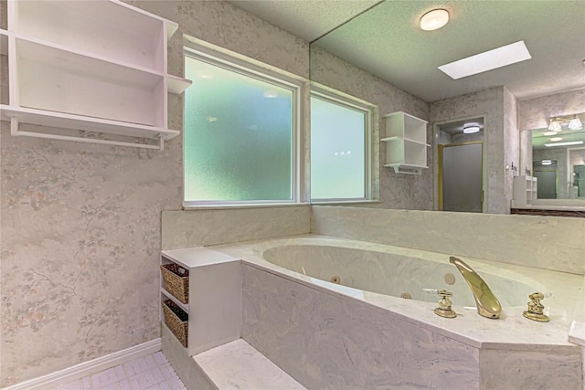 bathroom featuring tile patterned floors, tiled bath, and a skylight