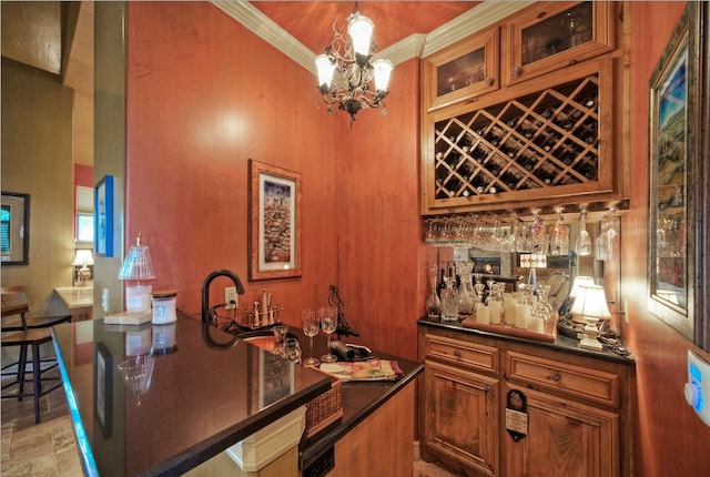 bar with decorative light fixtures, crown molding, and a chandelier