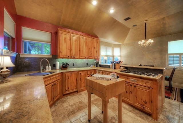 kitchen featuring pendant lighting, a wealth of natural light, and lofted ceiling