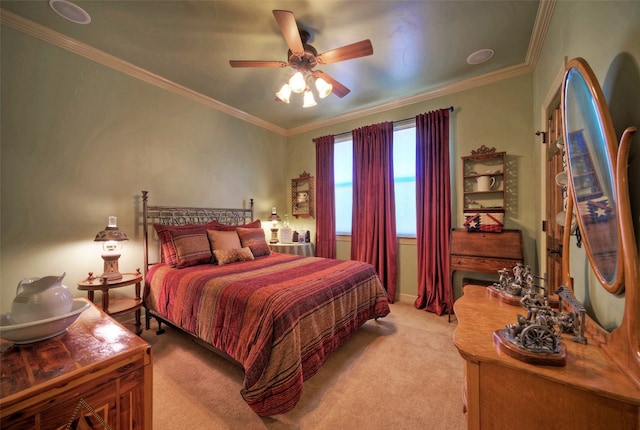 carpeted bedroom with ceiling fan and ornamental molding