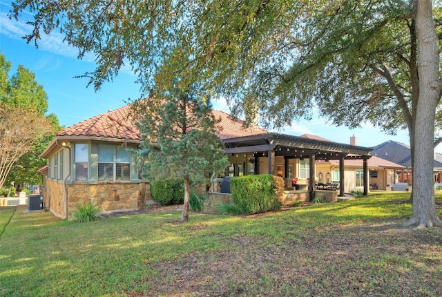 rear view of house featuring a yard and cooling unit