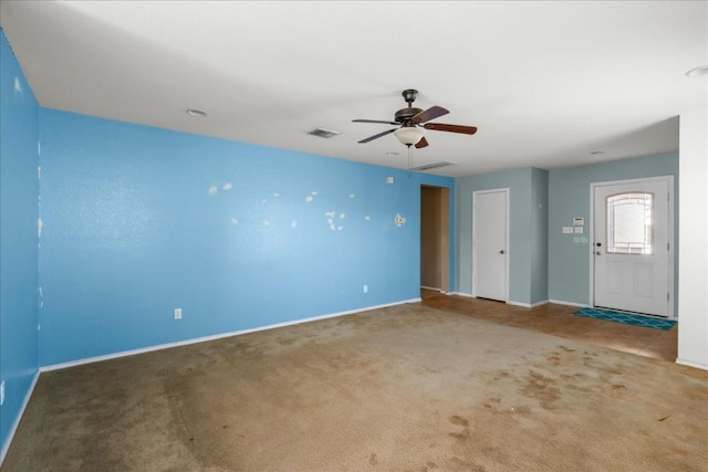 carpeted spare room featuring ceiling fan