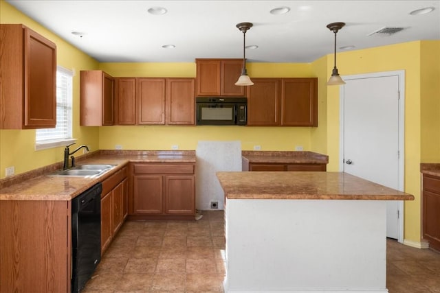 kitchen with sink, decorative light fixtures, a kitchen island, and black appliances