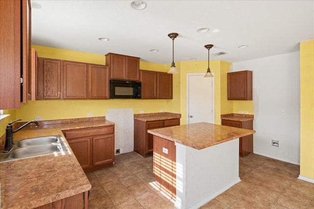 kitchen featuring pendant lighting, a center island, and sink