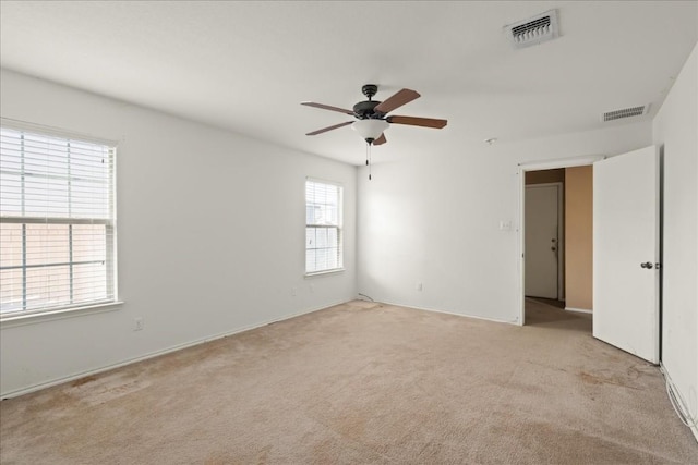 carpeted empty room featuring ceiling fan