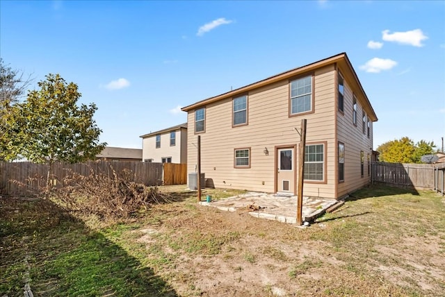 rear view of house featuring a yard