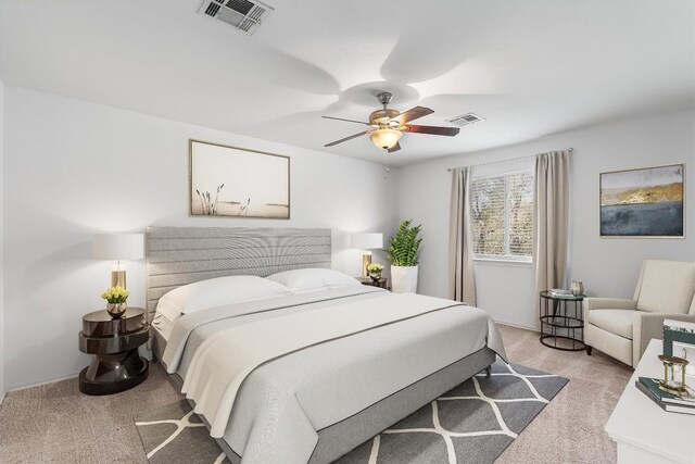 bedroom with ceiling fan and light colored carpet