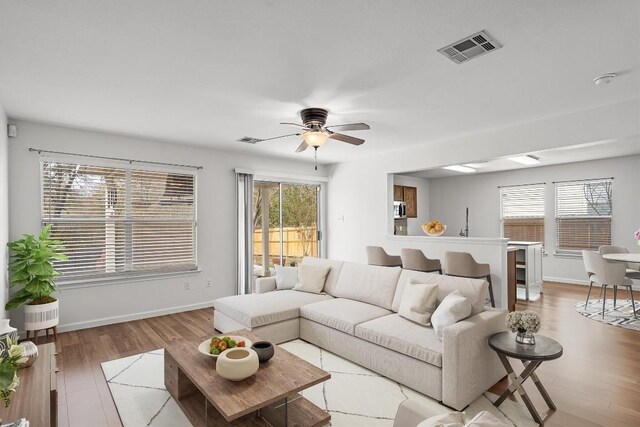 living room featuring hardwood / wood-style flooring and ceiling fan