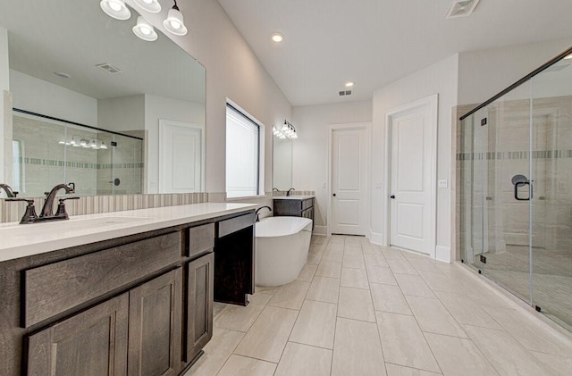 bathroom with tile patterned flooring, vanity, and shower with separate bathtub