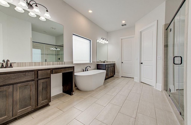 bathroom with plus walk in shower, vanity, and tile patterned flooring