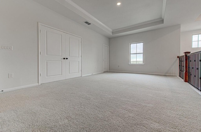 empty room with light colored carpet and a healthy amount of sunlight