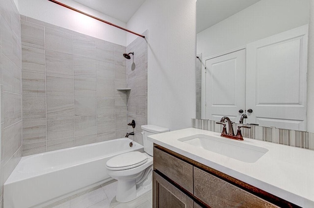 full bathroom with tiled shower / bath, vanity, and toilet