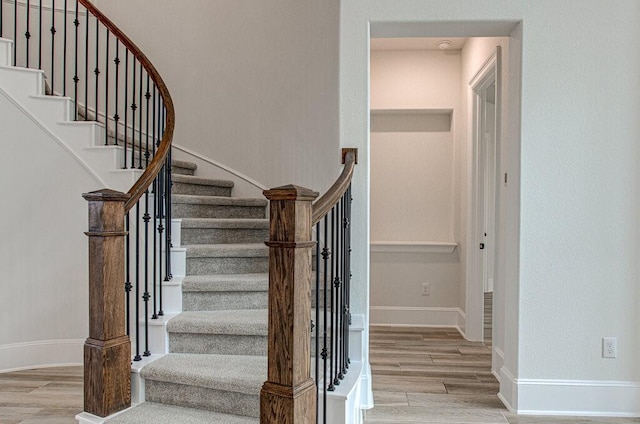 stairway with hardwood / wood-style floors