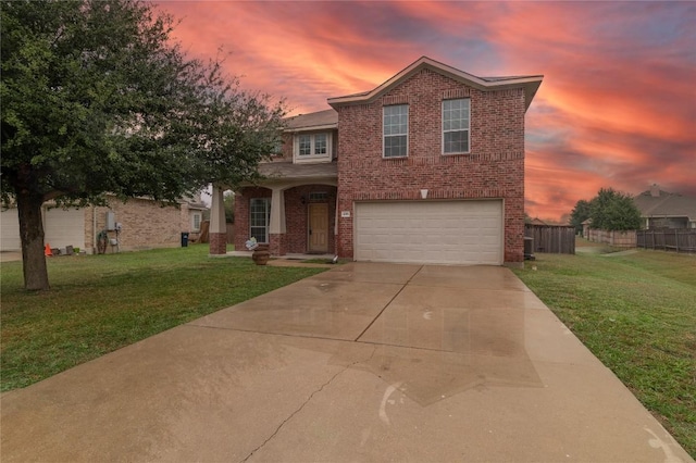 view of front of home with a garage and a yard