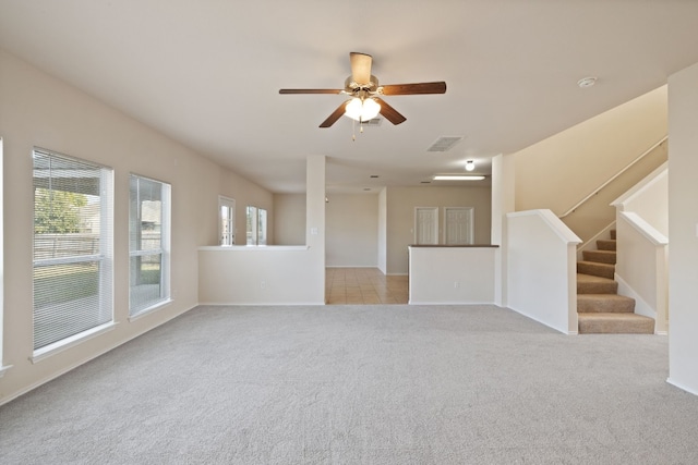 unfurnished living room with ceiling fan and light colored carpet