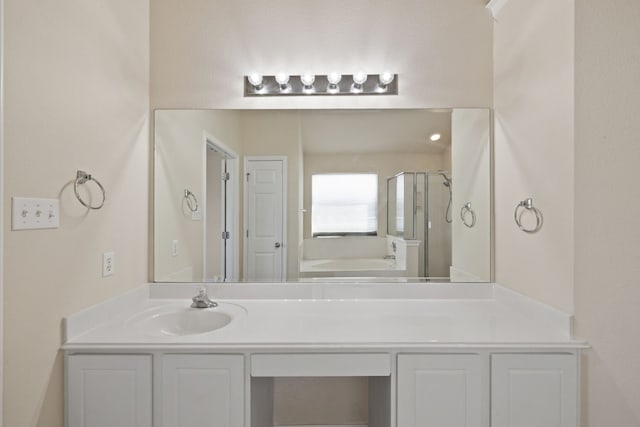 bathroom featuring vanity and separate shower and tub