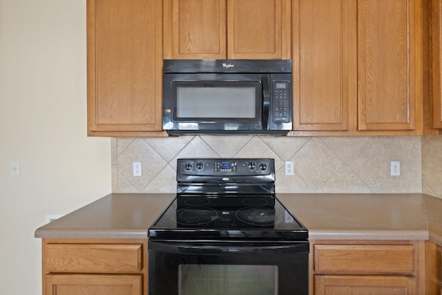 kitchen with decorative backsplash and black appliances