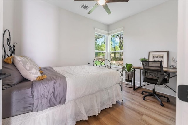 bedroom with wood-type flooring and ceiling fan