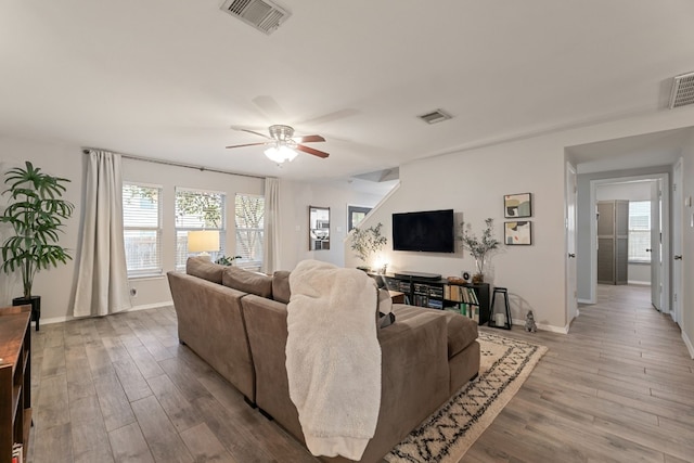 living room with ceiling fan and hardwood / wood-style flooring