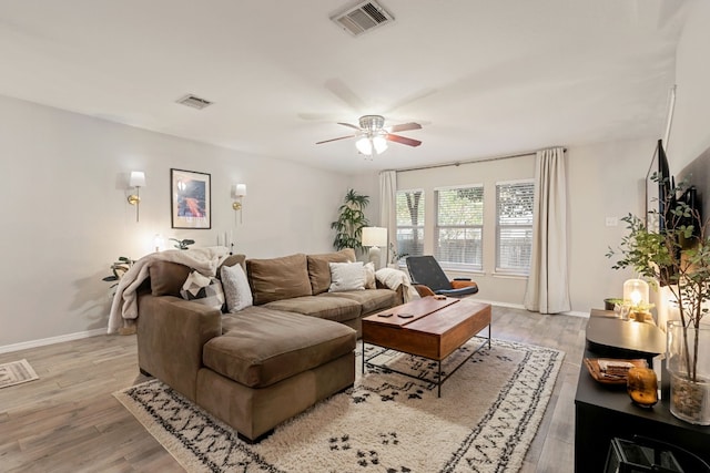 living room with ceiling fan and light wood-type flooring