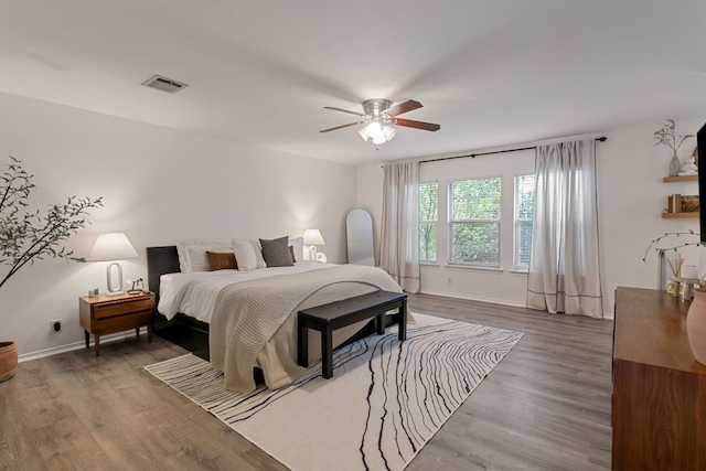 bedroom with hardwood / wood-style floors and ceiling fan