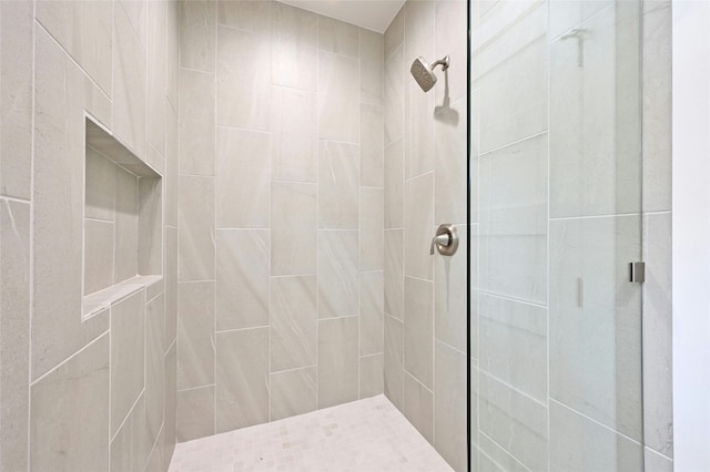 bathroom with a tile shower