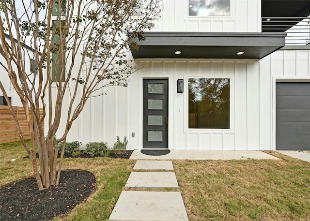 102 W Fawnridge Dr, Austin, TX 78753 - property entrance with board and batten siding, a garage, and fence