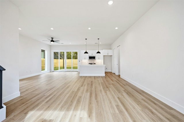 102 W Fawnridge Dr, Austin, TX 78753 - unfurnished living room with recessed lighting, ceiling fan, and light wood-type flooring