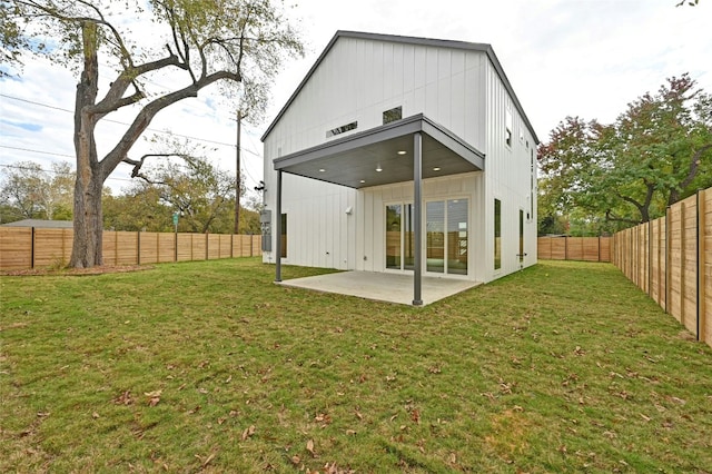102 W Fawnridge Dr, Austin, TX 78753 - rear view of property with board and batten siding, a patio, and a fenced backyard