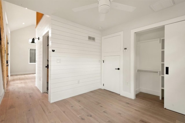 hallway with light hardwood / wood-style floors