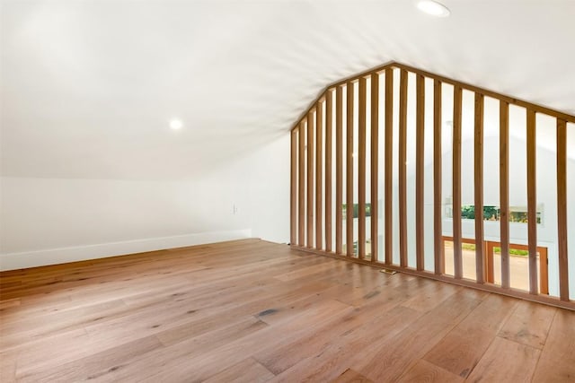 bonus room featuring lofted ceiling and light wood-type flooring