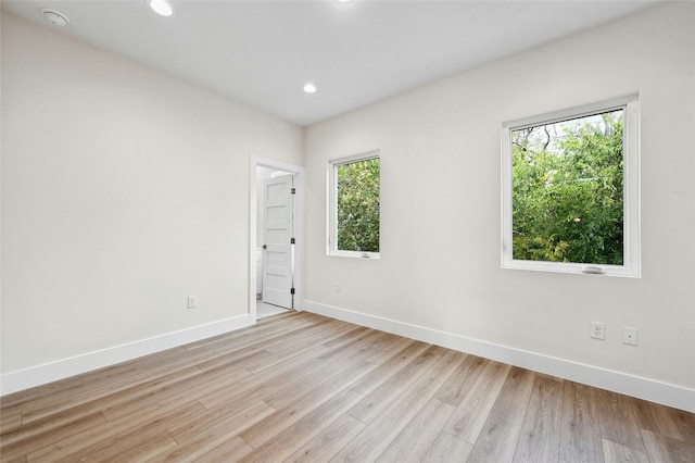 spare room with light hardwood / wood-style flooring