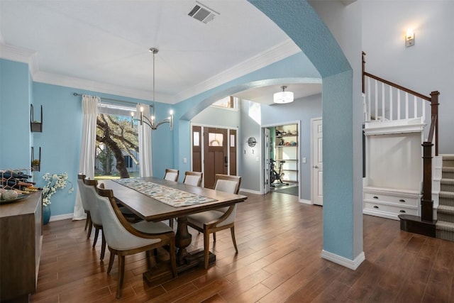 dining room featuring crown molding, a chandelier, and dark hardwood / wood-style floors