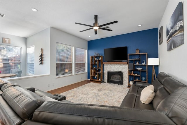 living room featuring visible vents, a ceiling fan, wood finished floors, and recessed lighting