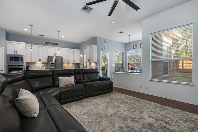 living room with ceiling fan and hardwood / wood-style flooring